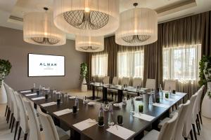 a conference room with tables and chairs and chandeliers at Almar Jesolo Resort & Spa in Lido di Jesolo