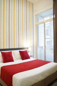 מיטה או מיטות בחדר ב-Hotel Cimarosa