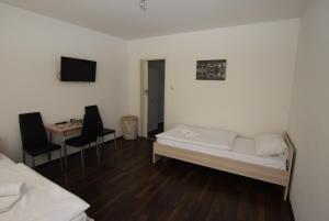 a room with a bed and a table and chairs at Apartment Wangen in Stuttgart