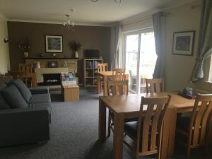 a living room with a table and chairs at Rothay House in Ambleside