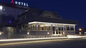 a building with a lot of windows at night at Asselta Hotel in Cerignola