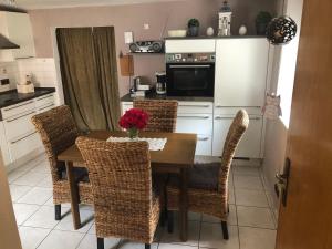 a kitchen with a table and chairs and a kitchen with a microwave at Ferienhaus in Sankt Aldegund