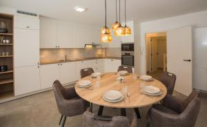 a kitchen and dining room with a wooden table and chairs at Maison .’Eau Mer.’ in Middelkerke