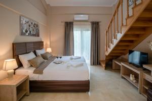 a bedroom with a large bed and a staircase at Valery Apartments in Pefkohori