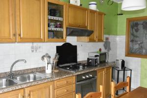 a kitchen with a sink and a stove top oven at casa vacanza DolceVita in Averara +8 photos