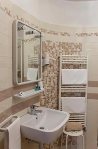 a bathroom with a sink and a mirror at Residence Italia in Finale Ligure