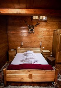 a bedroom with a bed in a wooden room at Pension Vanatorul in Vatra Dornei