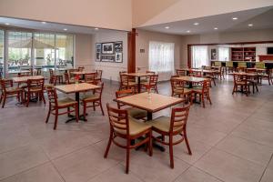 a dining room with wooden tables and chairs at Country Inn & Suites by Radisson, Beckley, WV in Beckley