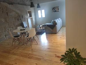 a living room with a table and chairs and a couch at Hospédate Pontevedra in Pontevedra +13 photos