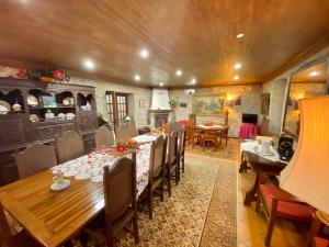 a dining room with a long table and chairs at Casa do Outeirinho- Turismo Rural in Penedo