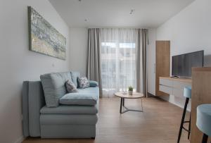 a living room with a couch and a tv at IvMaLu Apartments in Tučepi