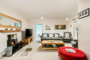 a living room with a couch and a table at Mews Hill, 5 bedroom New Forest Holiday Cottage in Fordingbridge