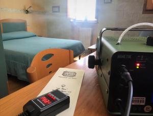a room with a camera on a table next to a bed at Garnì B&B La Rua-Pescocostanzo in Pescocostanzo +33 photos