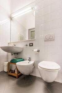 a white bathroom with a sink and a toilet at B&B Entro Le Mura in Bergamo