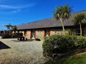 a house with a palm tree in front of it at Moneylands Farm Self-Catering Apartments in Arklow