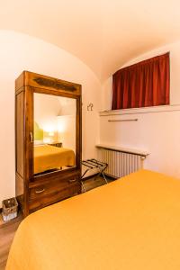 a bedroom with a mirror and a bed in a room at B&B Entro Le Mura in Bergamo