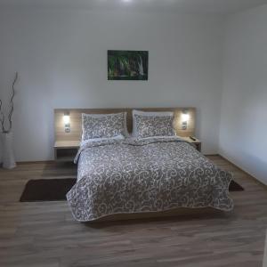 a bedroom with a large bed and two night stands at Plitvice House Rosha in Plitvička Jezera