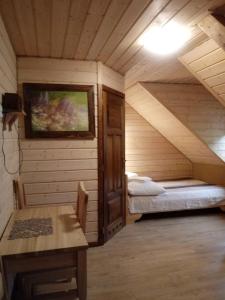 um quarto com 2 camas num chalé de madeira em Dom Gościnny BIERWIONO em Cisna