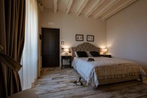 a bedroom with a bed and a table and two lamps at Donna Carolina Luxury rooms in Cefalù