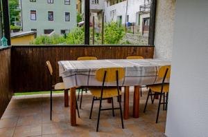 a table and chairs on a patio with a window at Holiday house Tinca in Most na Soči