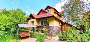 a house with a gazebo in front of it at Gutsulska Oselya in Yaremche