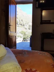 a bedroom with a bed with a view of a mountain at Casa Berna in Masca