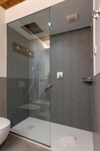a glass shower in a bathroom with a toilet at Al Gabbiano "Suite" in Portovenere