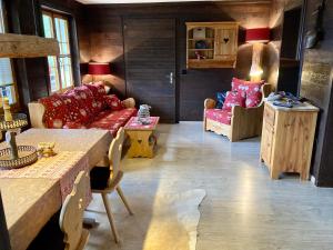 a living room with a couch and a table at Chalet Ariane in Blatten bei Naters