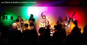 a group of people on a stage playing music at La Baleine Endiablée Microbrasserie in Rivière-Ouelle