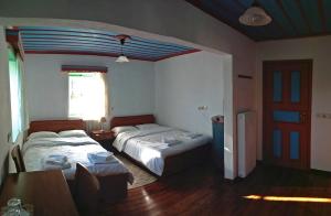 Postel nebo postele na pokoji v ubytování Guesthouse Iro