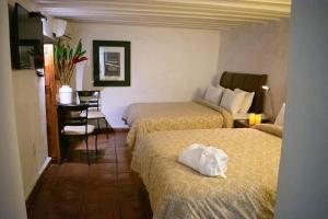 Postel nebo postele na pokoji v ubytování Casa Aspeytia Hotel Boutique