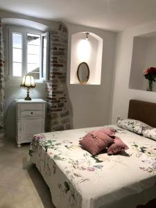 a bedroom with a bed and a table and a mirror at New renovated Old Town Martiva Apartment in Kotor