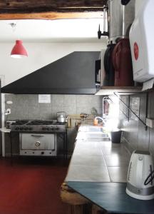 a kitchen with a stove and a counter top at HOPA-Home Patagonia Hostel & Bar in San Carlos de Bariloche