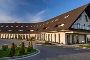 a large building with a brown roof at Hotel Bachledówka in Zakopane