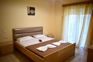 a bedroom with a bed with towels on it at Vasw Apartment in Ágios Nikólaos