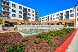 a garden in front of a building with a fountain at Churchill Living at Anton Menlo in Menlo Park