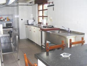 uma cozinha com um lavatório e uma bancada em Casa Antuña em Leceñes