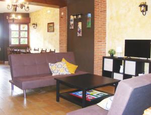 a living room with a couch and a coffee table at Casa Antuña in Leceñes