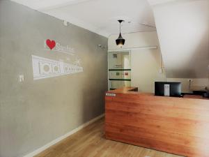 a room with a counter and a sign on the wall at Pousada Beira Mar in Santos