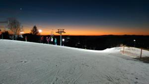 a group of people standing at the top of a snow covered slope at Góralski domek na szczycie in Zwardoń