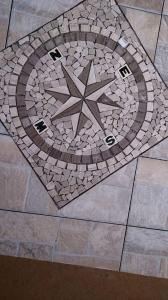 a mosaic tile floor with a star on it at La Rosa dei Venti in Cantagrillo