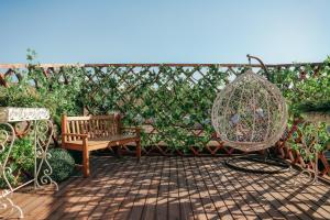 a patio with a hammock and a swing at 7 Boutique Hotel in Ustʼ-Kamenogorsk