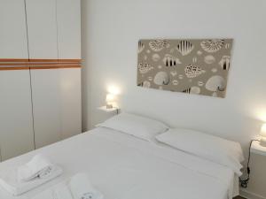 Кровать или кровати в номере La Finestra su Stintino