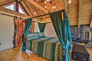 a bedroom with a bed in a room with wooden ceilings at Red Sweetheart Barn Studio with Mtn and River Views! in Westminster