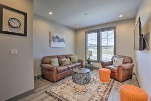 a living room with leather furniture and a clock at 20 Mi to Winter Park Mtn-View Townhome with Balcony in Granby