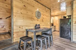 a dining room with a table and two stools at Modern Gatlinburg Cabin with Hot Tub, Game Room in Gatlinburg