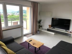 a living room with a couch and a large television at Apartment AusZeit in Bad Kissingen