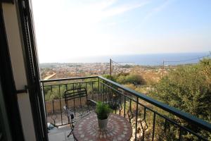 a balcony with a table and a view of the ocean at Kiparissia Castle & Sea view in Kyparissia