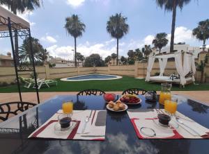 a table with a plate of food on it at La Atalaya in Benalmádena