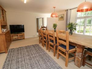 a dining room with a wooden table and chairs at 9 Copes Gardens in Truro